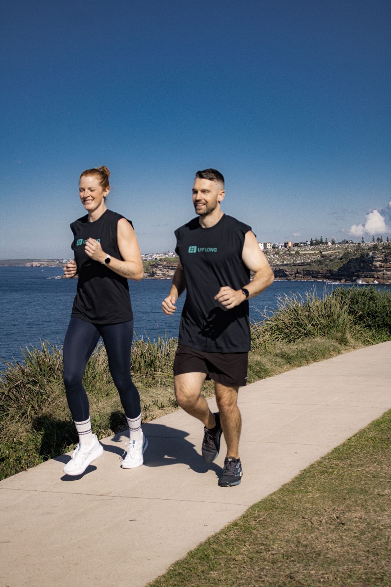Couple running on a coastal trail
